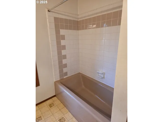 a bathroom with a bathtub and shower