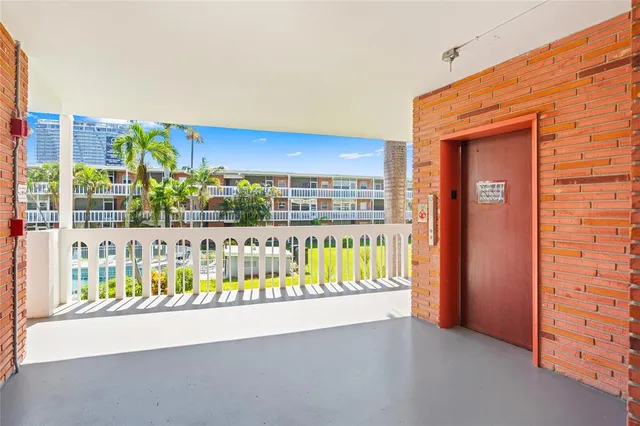 a view of a balcony with a couch and iron fence