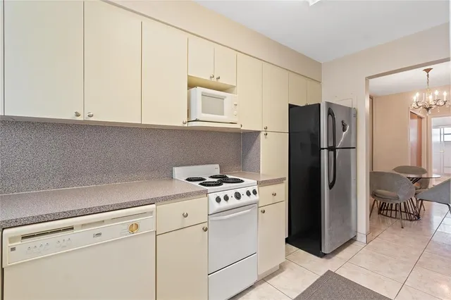 a kitchen with cabinets and stainless steel appliances