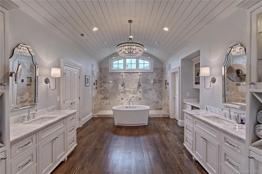 2346 Overhill Road Charlotte, NC 28211 - Photo 19 of 38 a spacious bathroom with a double vanity sink a mirror and a bathtub