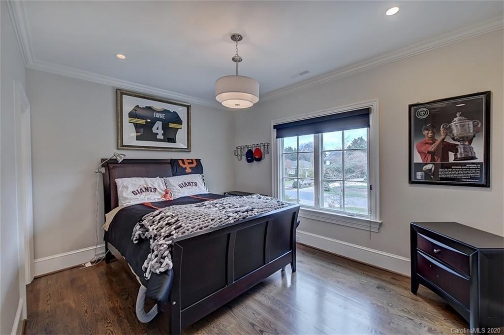 2346 Overhill Road Charlotte, NC 28211 - Photo 22 of 38 a bedroom with a bed wooden floor and window