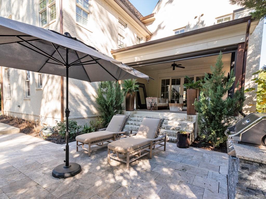 2346 Overhill Road Charlotte, NC 28211 - Photo 30 of 38 a view of patio with a table and chairs under an umbrella