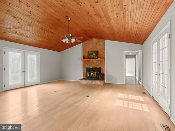 a bathroom with a sink a toilet a mirror and shower