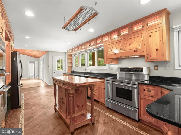 a front view of a house with a yard and potted plants