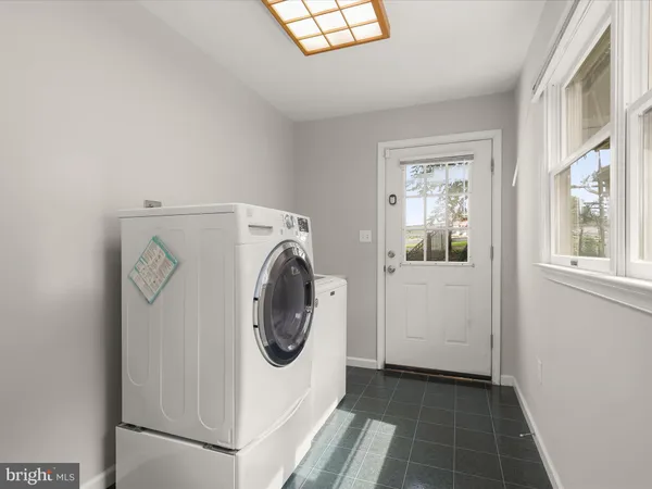 an aerial view of a residential houses with outdoor space and trees