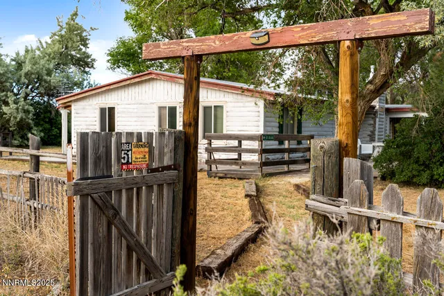 a view of a patio with table and chairs under an umbrella with wooden floor
