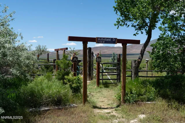 a front view of a house with a yard and mountain view
