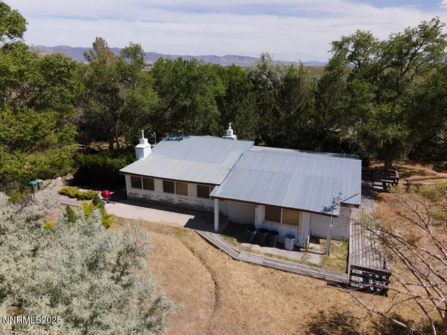 an aerial view of a house with a yard and sitting area