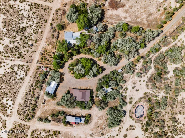 a view of house with a yard and potted plants