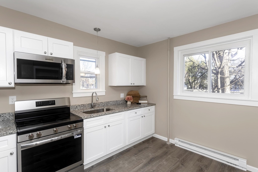 49 View Street Holyoke, MA 01040 - Photo 1 of 34 a kitchen with a stove and a microwave
