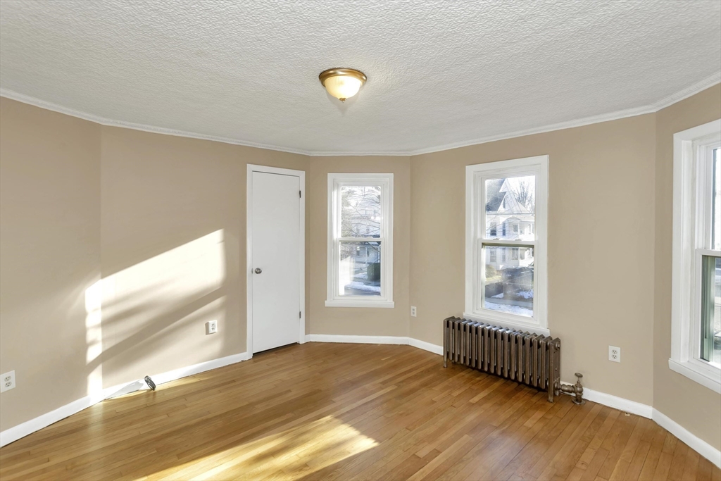 49 View Street Holyoke, MA 01040 - Photo 16 of 34 a view of an empty room with wooden floor and a window