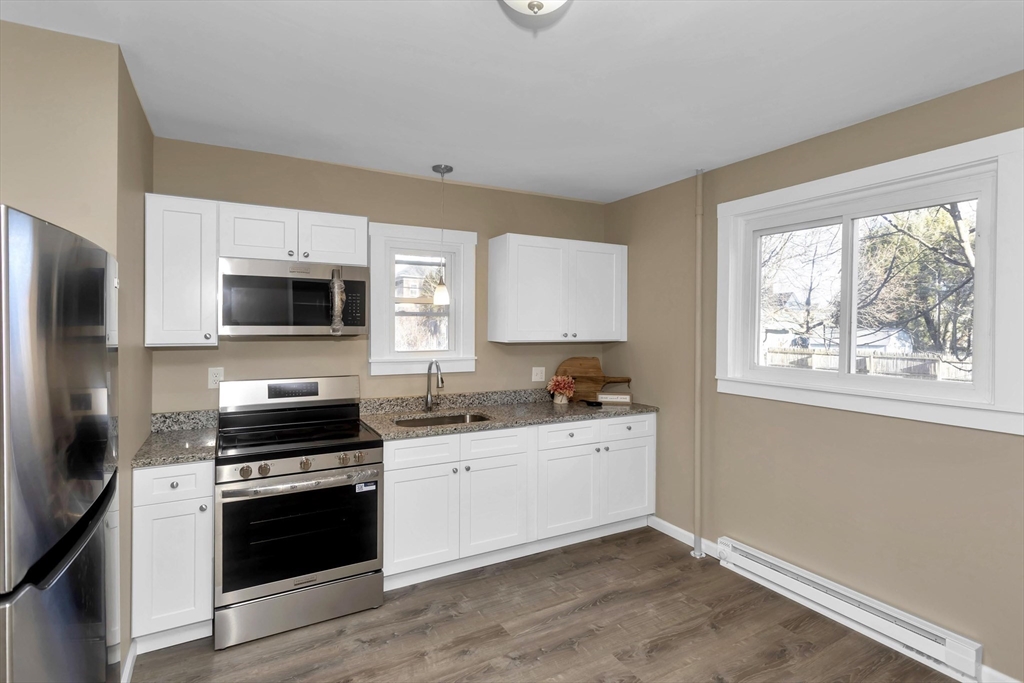 49 View Street Holyoke, MA 01040 - Photo 2 of 34 a kitchen with stainless steel appliances a stove microwave and sink