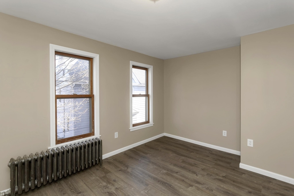 49 View Street Holyoke, MA 01040 - Photo 23 of 34 a view of an empty room with wooden floor and a window