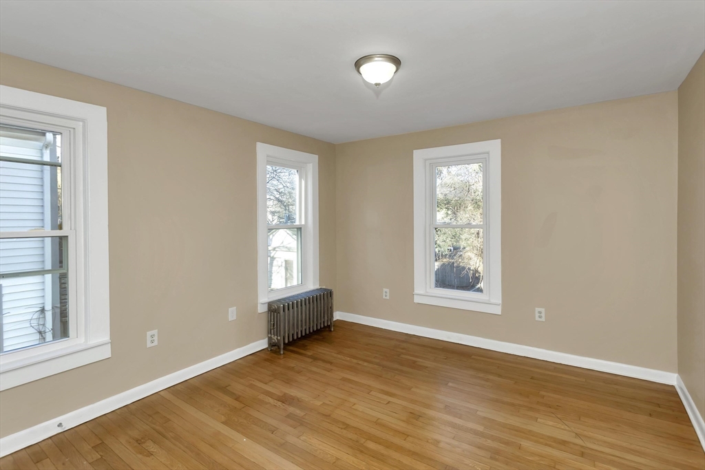 49 View Street Holyoke, MA 01040 - Photo 24 of 34 an empty room with wooden floor and windows