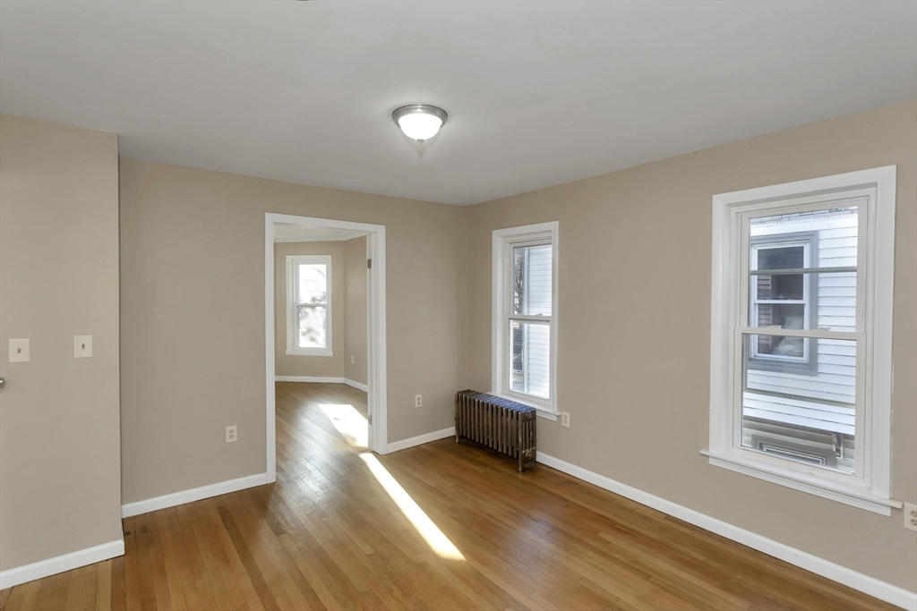 49 View Street Holyoke, MA 01040 - Photo 29 of 34 a view of an empty room with wooden floor and a window