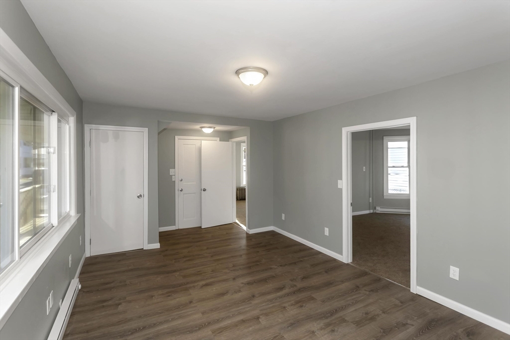 49 View Street Holyoke, MA 01040 - Photo 7 of 34 a view of an empty room with wooden floor and a window