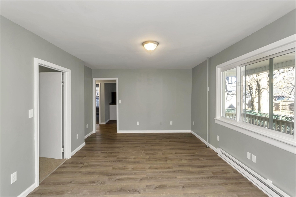 49 View Street Holyoke, MA 01040 - Photo 10 of 34 a view of a hallway with wooden floor and a window