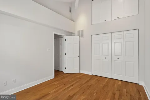 a view of an empty room with wooden floor