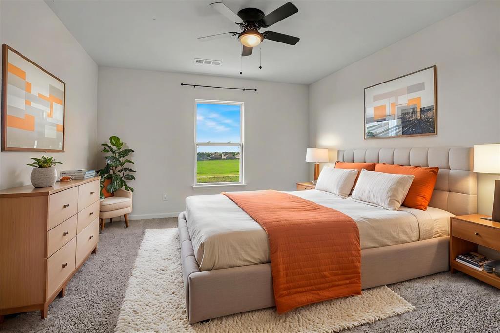 125 Sammy Venus, TX 76084 - Photo 25 of 39 Spacious room featuring neutral carpeting, a large window, a ceiling fan, and a built-in upholstered headboard