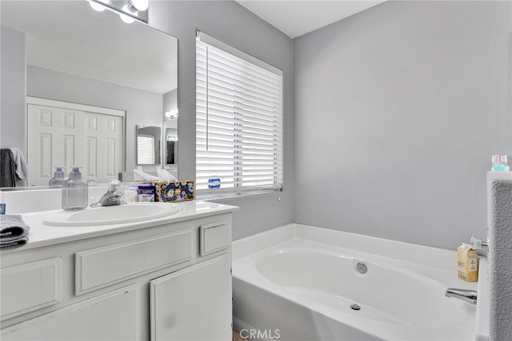 20403 Ochoa Road Apple Valley, CA 92307 - Photo 31 of 48 a bathroom with a sink a tub and a window