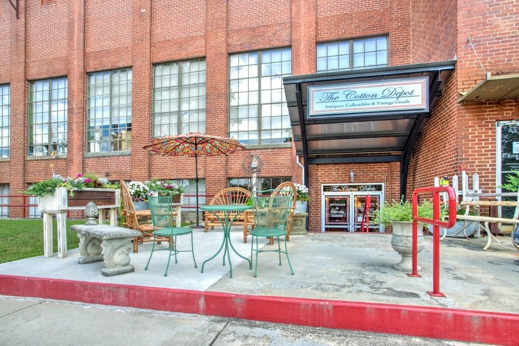 229 East Marable Street Monroe, GA 30655 - Photo 31 of 39 a view of a patio with a table and chairs and potted plants