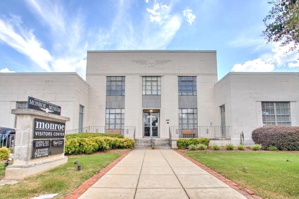229 East Marable Street Monroe, GA 30655 - Photo 32 of 39 a front view of a house with a yard and garage