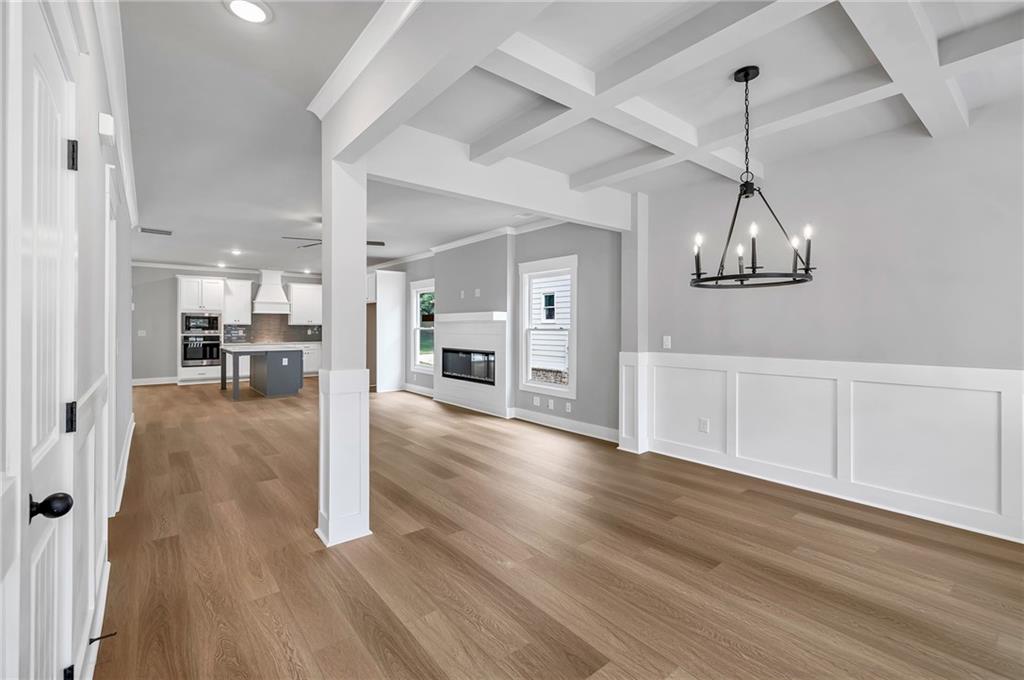229 East Marable Street Monroe, GA 30655 - Photo 4 of 39 a view of a room with wooden floor kitchen view and a window