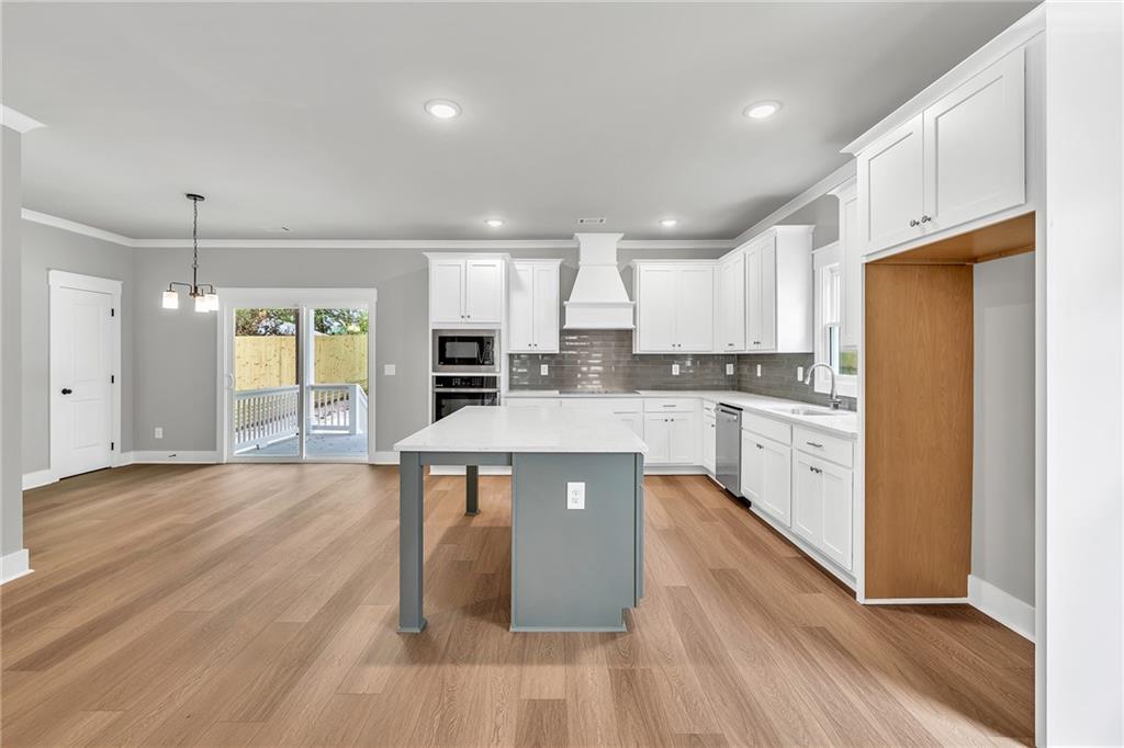 229 East Marable Street Monroe, GA 30655 - Photo 8 of 39 a kitchen with kitchen island a counter top space a sink stainless steel appliances and cabinets