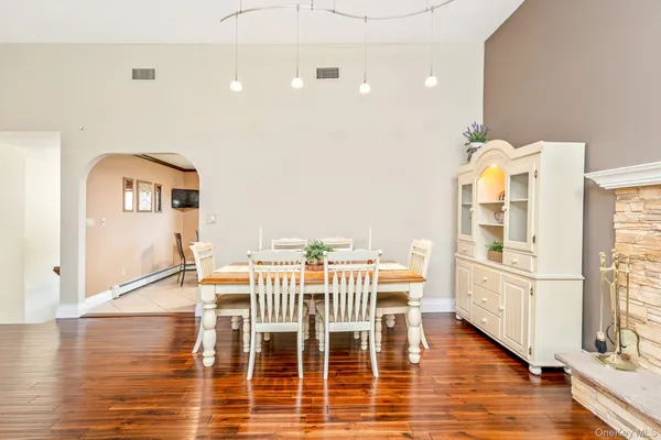 a view of a kitchen with furniture and wooden floor