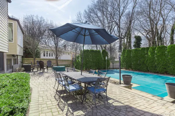 a view of backyard with seating space and trees