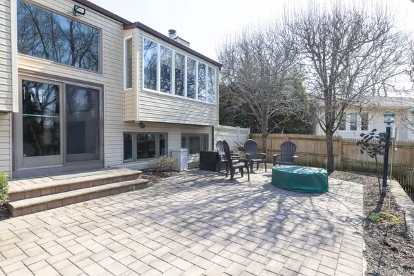 a view of a patio with chair and tables