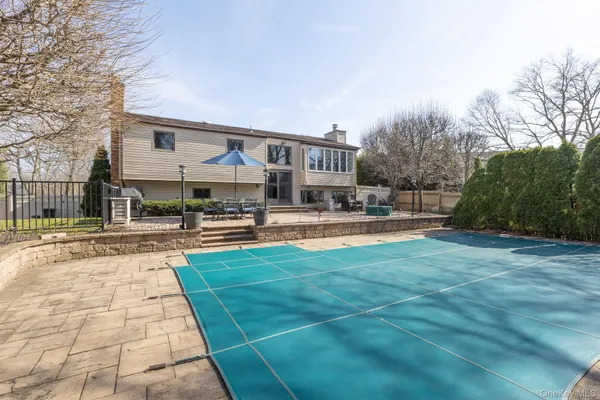 a swimming pool with outdoor seating and yard