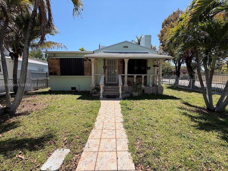 446 Northwest 45th Street Miami, FL 33127 - Photo 1 of 15 a front view of a house with a yard and potted plants