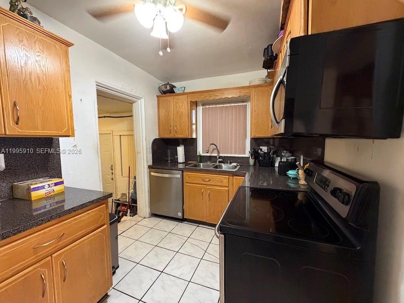 446 Northwest 45th Street Miami, FL 33127 - Photo 12 of 15 a kitchen with a sink a stove and cabinets