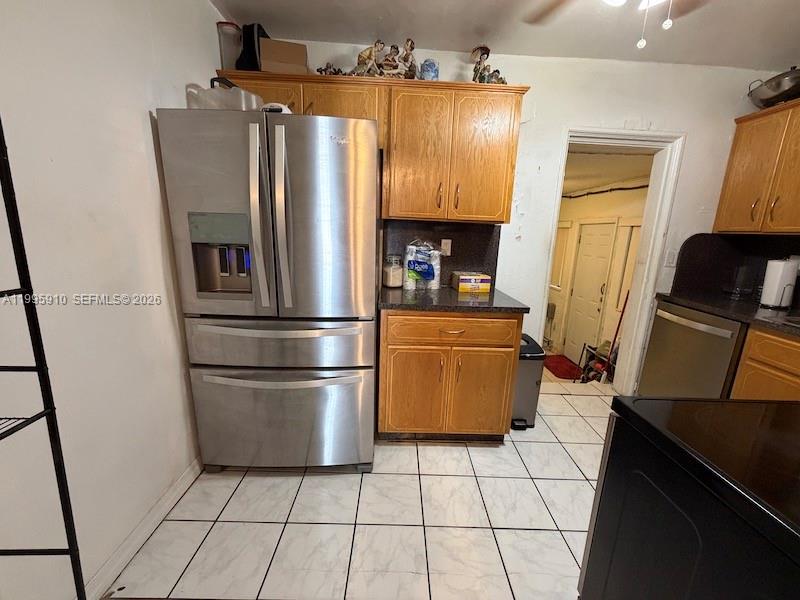 446 Northwest 45th Street Miami, FL 33127 - Photo 13 of 15 a kitchen with stainless steel appliances granite countertop a refrigerator and a stove