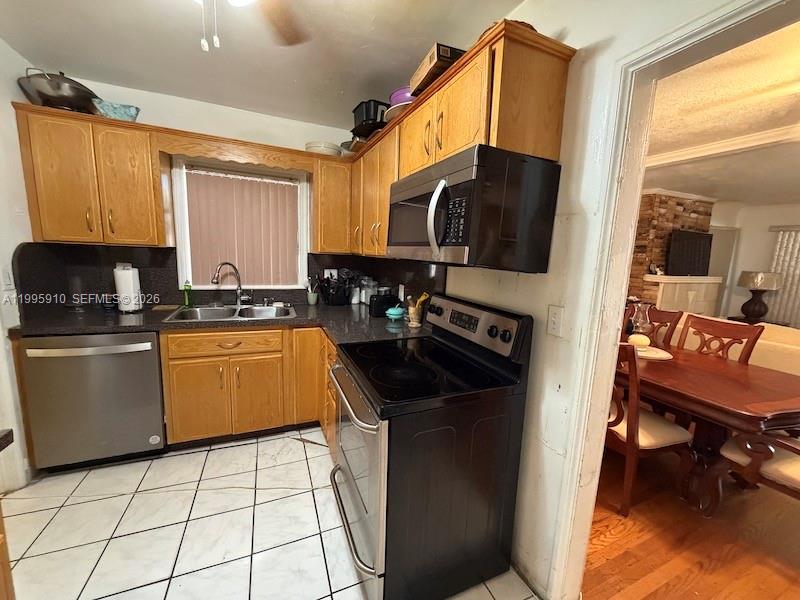 446 Northwest 45th Street Miami, FL 33127 - Photo 14 of 15 a kitchen with a sink a stove and a refrigerator