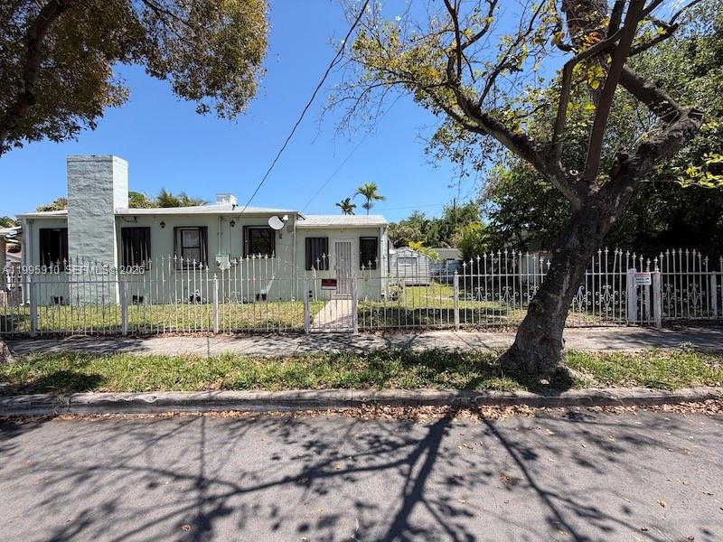 446 Northwest 45th Street Miami, FL 33127 - Photo 3 of 15 a front view of a house with garden
