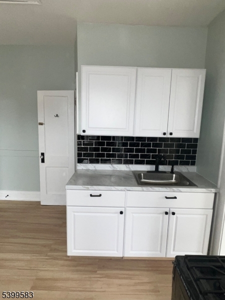 193 President Street, Unit 9 Passaic, NJ 07055 - Photo 3 of 10 a view of kitchen with granite countertop white cabinets and sink