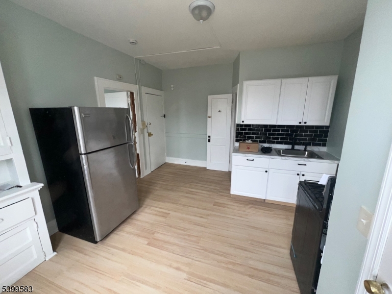 193 President Street, Unit 9 Passaic, NJ 07055 - Photo 5 of 10 a kitchen with granite countertop a refrigerator a sink and a stove