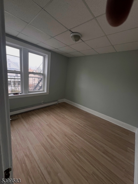 193 President Street, Unit 9 Passaic, NJ 07055 - Photo 10 of 10 an empty room with wooden floor and windows