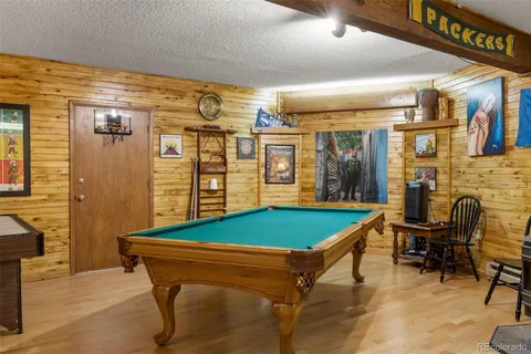 a room with pool table and windows