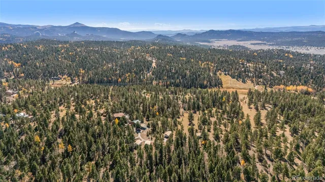 a view of a town with mountains in the background