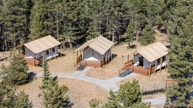 an aerial view of a house with a yard and sitting area