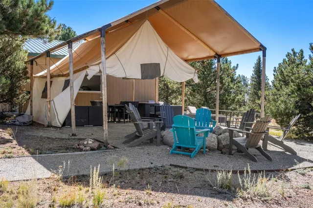 a view of a chair and table in the backyard