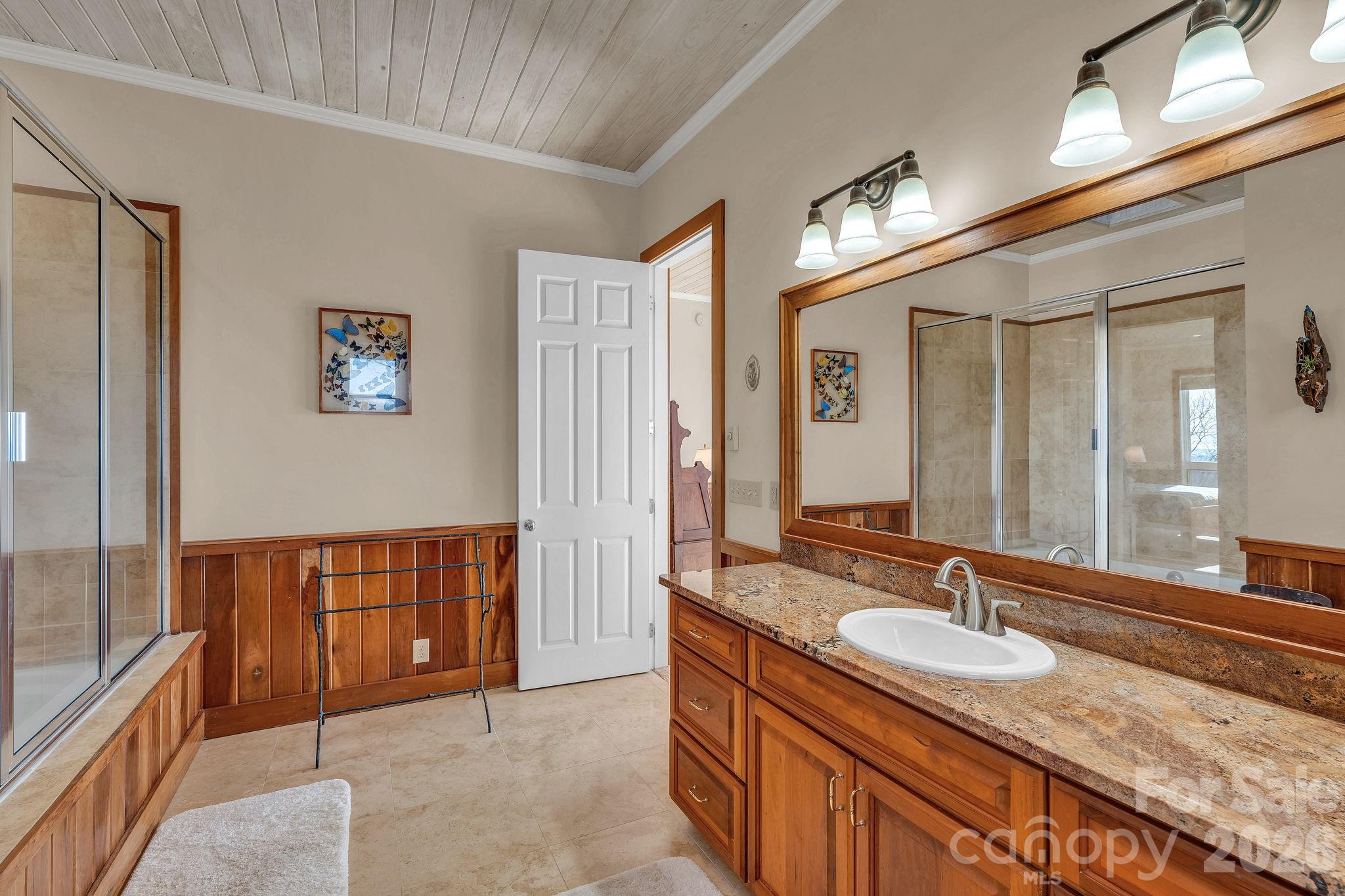 933 Thunder Ridge Lane, Unit 4 & 2 Lenoir, NC 28645 - Photo 27 of 45 a bathroom with a granite countertop sink and a large mirror