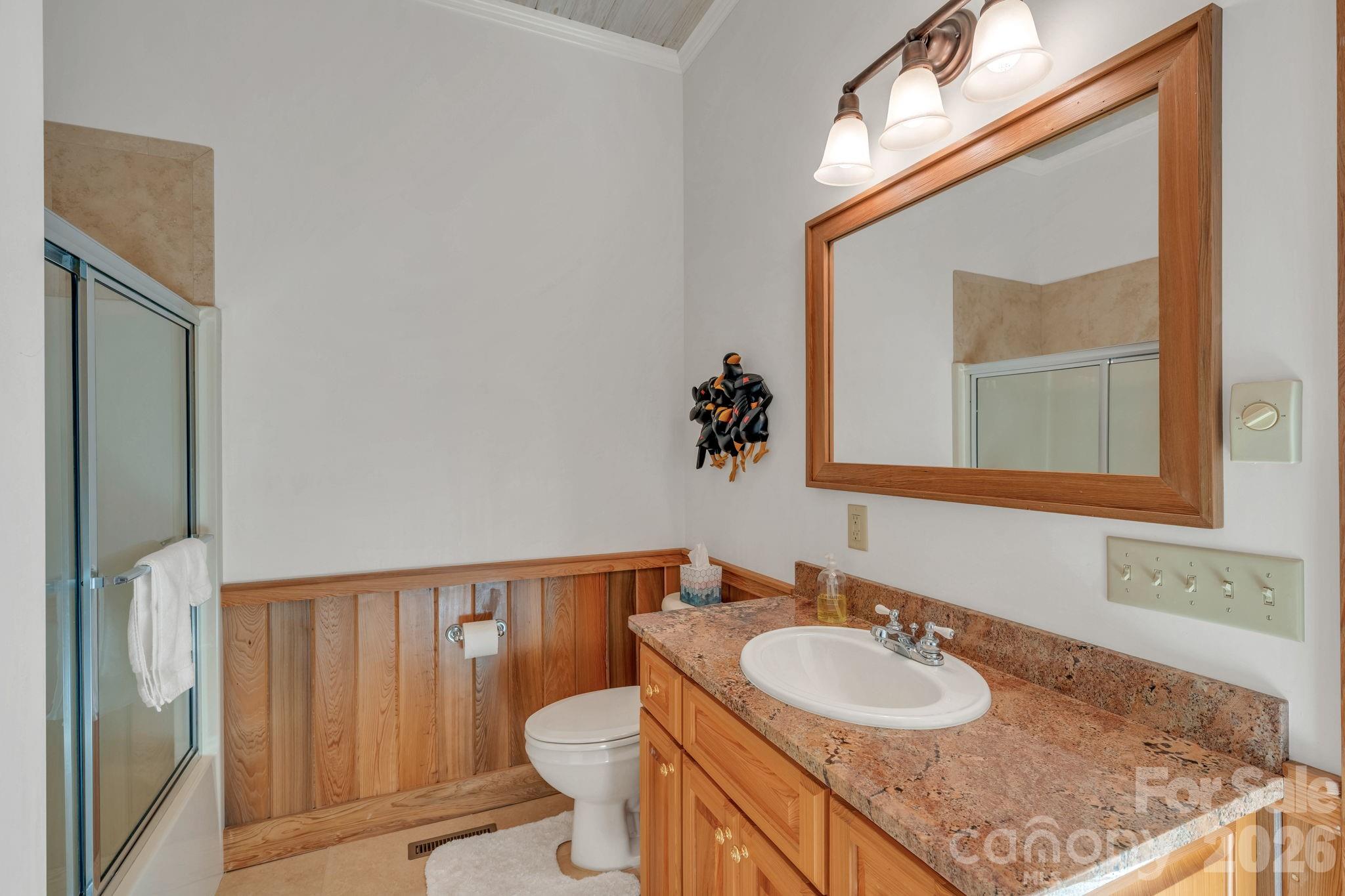 933 Thunder Ridge Lane, Unit 4 & 2 Lenoir, NC 28645 - Photo 31 of 45 a bathroom with a granite countertop sink and a mirror with toilet