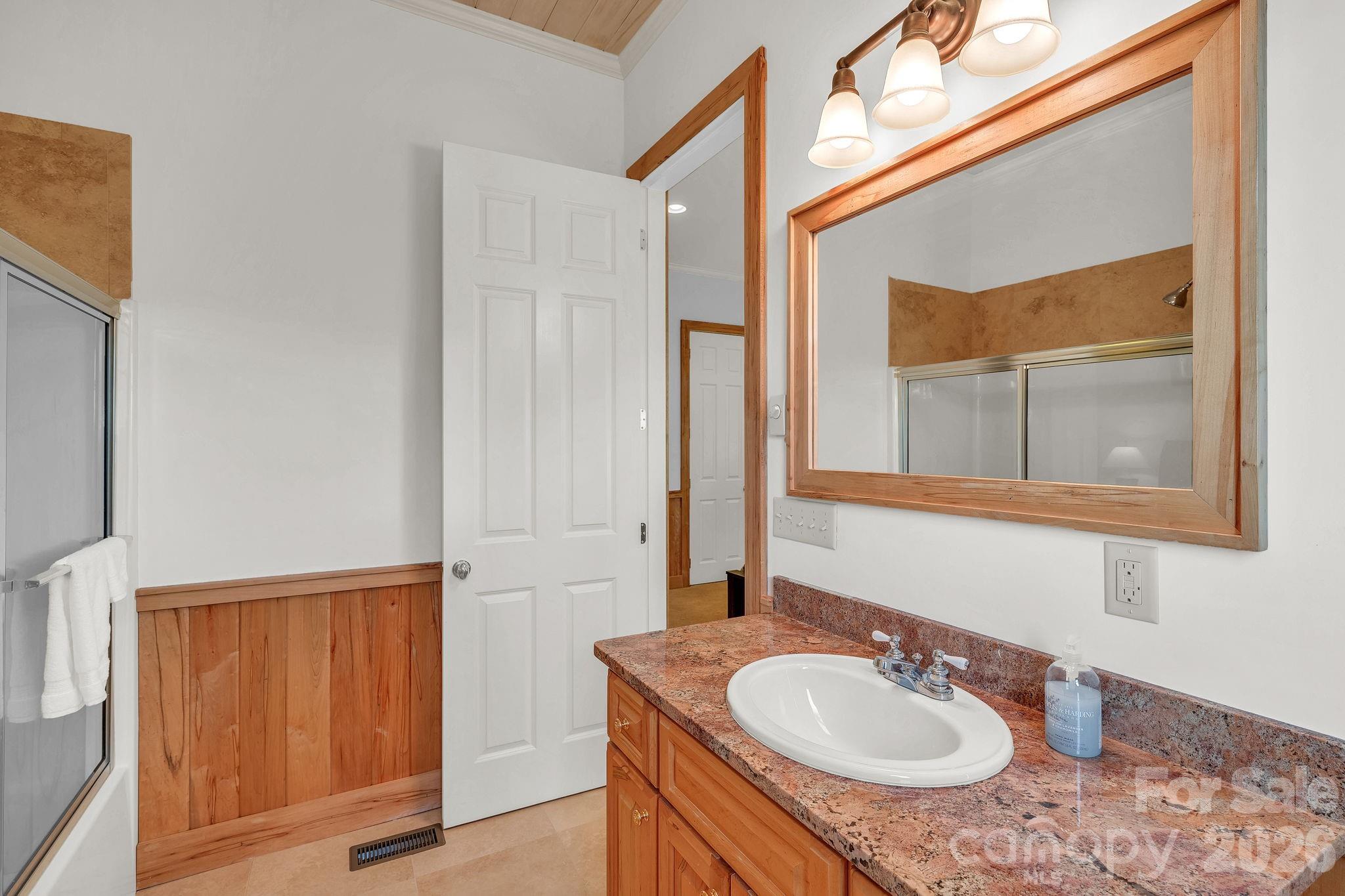 933 Thunder Ridge Lane, Unit 4 & 2 Lenoir, NC 28645 - Photo 32 of 45 a bathroom with a sink and a mirror