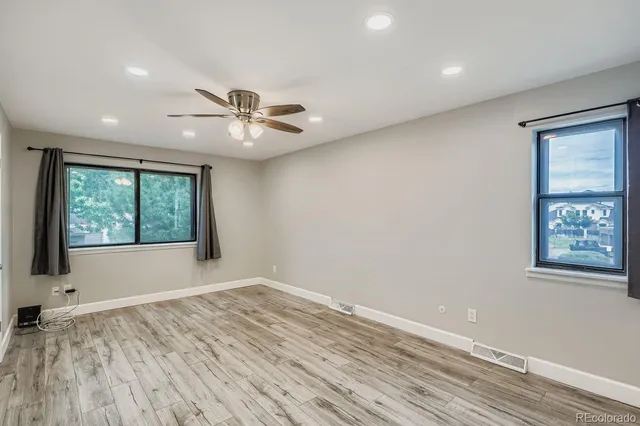 wooden floor in an empty room with a window