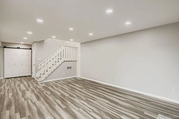 a view of an empty room with wooden floor