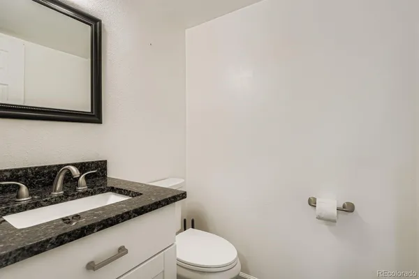 a white toilet sitting next to a sink